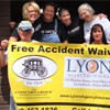 Group photo with Lyons Agency Banner - united way of york county insurance agency kennebunk maine