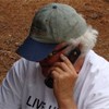 man in hat on a cellular phone - united way of york county insurance agency kennebunk maine